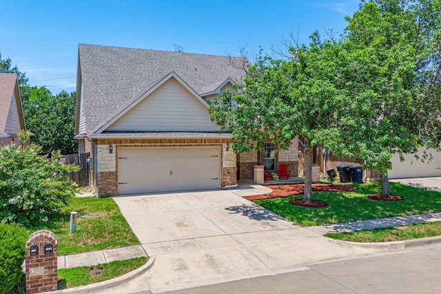 view of front of home featuring a garage, driveway, a shingled roof, stone siding, and a front lawn