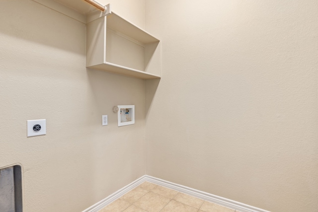 laundry room featuring laundry area, light tile patterned floors, baseboards, hookup for an electric dryer, and washer hookup