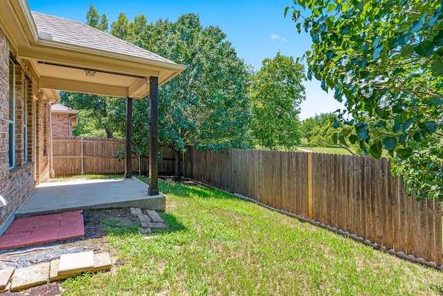 view of yard featuring a patio area and a fenced backyard