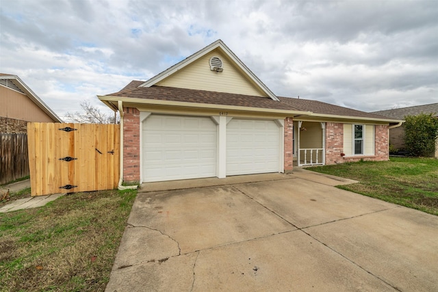 ranch-style house featuring concrete driveway, an attached garage, a gate, fence, and brick siding