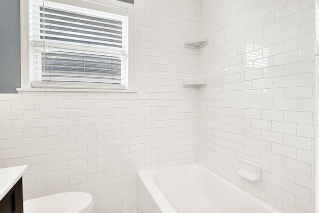 bathroom featuring washtub / shower combination, tile walls, vanity, and toilet