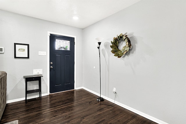 entrance foyer featuring baseboards and wood finished floors