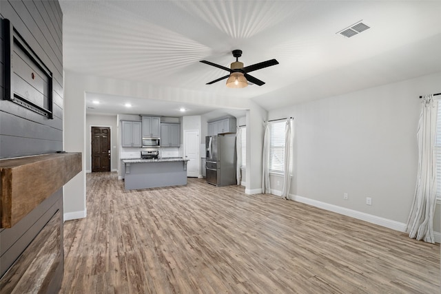 unfurnished living room with recessed lighting, visible vents, a ceiling fan, light wood-type flooring, and baseboards