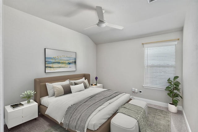 bedroom with dark colored carpet, vaulted ceiling, baseboards, and ceiling fan