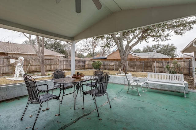 view of patio featuring ceiling fan, outdoor dining area, and a fenced backyard