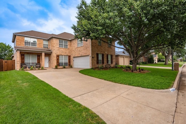 traditional home with brick siding, an attached garage, fence, driveway, and a front lawn