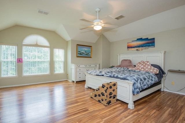 bedroom with light wood-type flooring, visible vents, and lofted ceiling