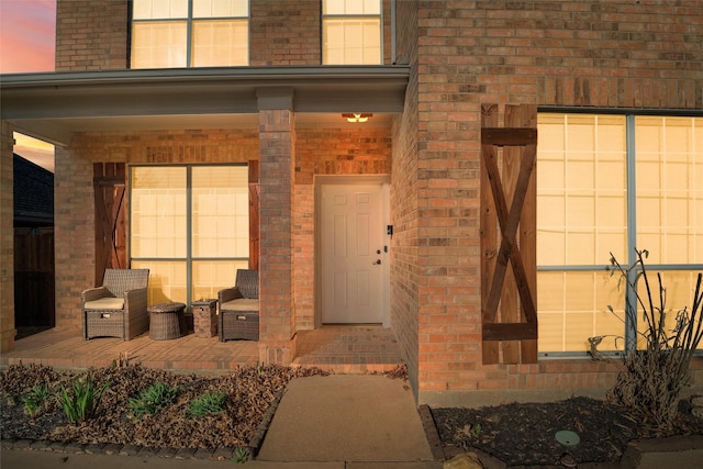 6500 High Brook Dr, Fort Worth, TX 76132 - exterior entry at dusk featuring covered porch and brick siding