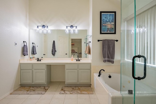 bathroom with double vanity, tile patterned flooring, a sink, and a bath