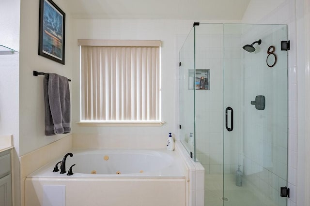 bathroom with a whirlpool tub, a shower stall, and vanity