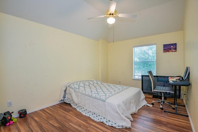 bedroom with lofted ceiling, ceiling fan, wood finished floors, and baseboards