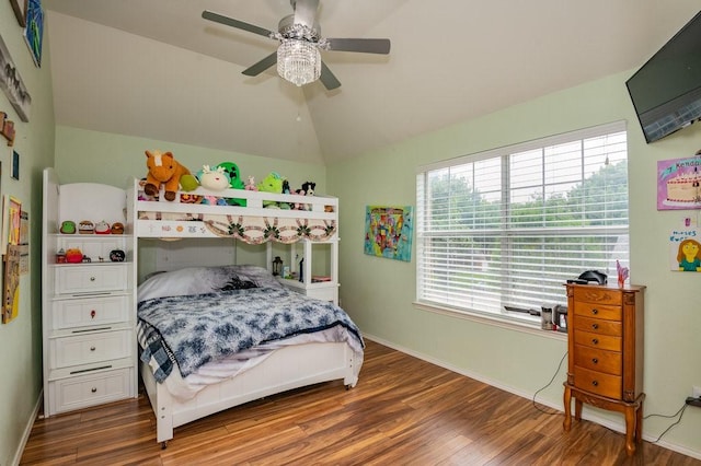 bedroom featuring lofted ceiling, ceiling fan, baseboards, and wood finished floors