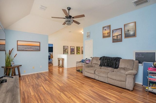 living area featuring ceiling fan, visible vents, vaulted ceiling, and wood finished floors