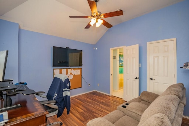 home office featuring lofted ceiling, wood finished floors, a ceiling fan, and baseboards