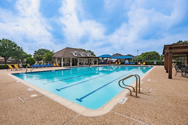 community pool featuring a patio area and fence