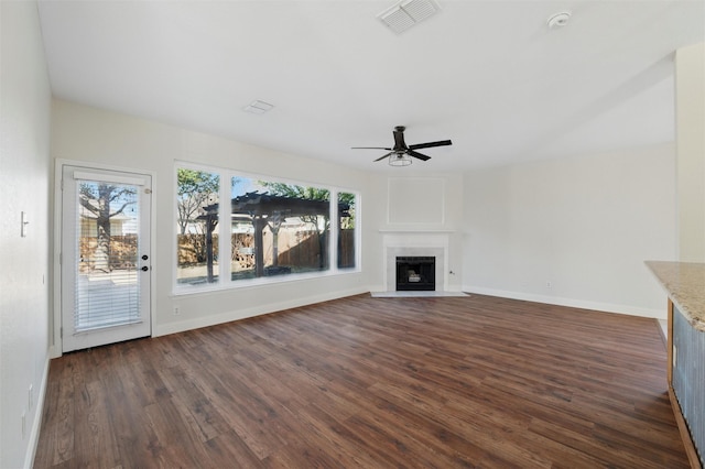 6500 High Brook Dr, Fort Worth, TX 76132 - unfurnished living room featuring dark wood-style floors, visible vents, ceiling fan, and a healthy amount of sunlight