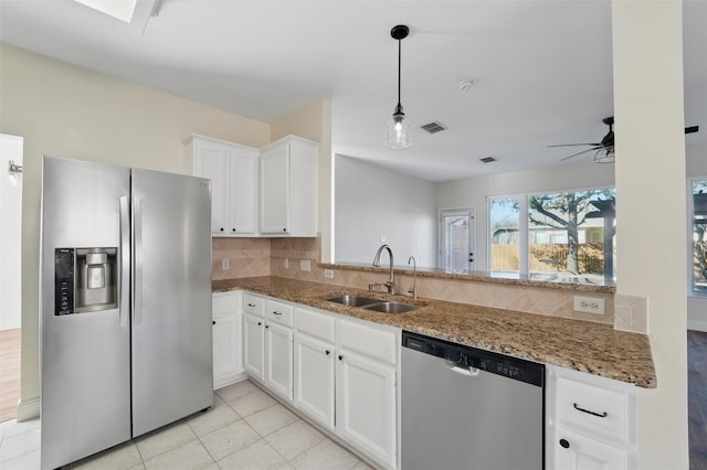 6500 High Brook Dr, Fort Worth, TX 76132 - kitchen featuring light stone counters, a sink, appliances with stainless steel finishes, visible vents, and decorative backsplash