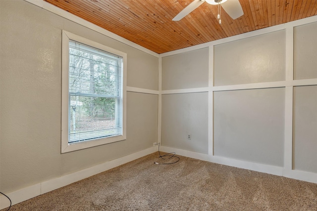 spare room with a textured wall, wood ceiling, ceiling fan, carpet floors, and a decorative wall