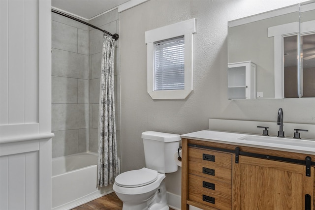 full bath featuring a textured wall, vanity, toilet, and shower / bathtub combination with curtain