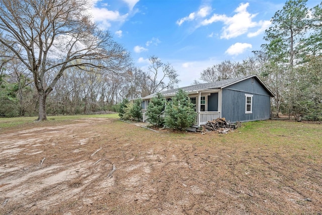 exterior space featuring a porch and a front lawn