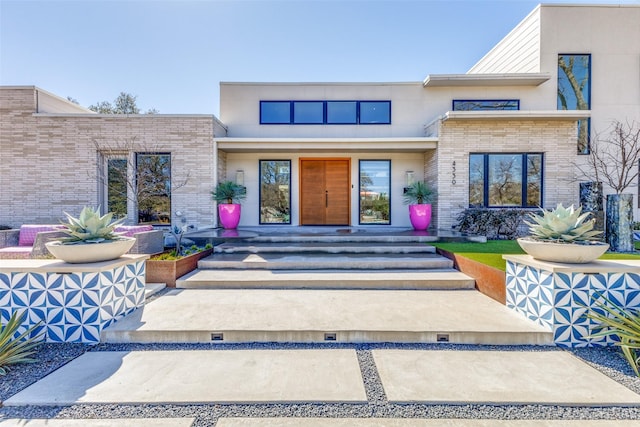 entrance to property featuring brick siding