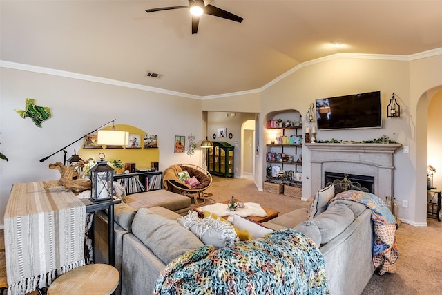 living room with visible vents, arched walkways, vaulted ceiling, carpet floors, and a fireplace