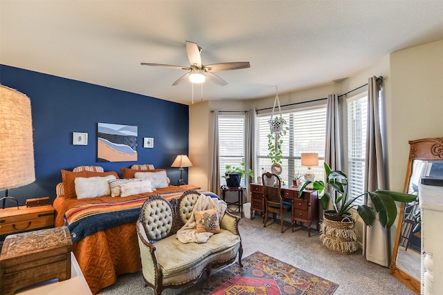 carpeted bedroom with ceiling fan and multiple windows