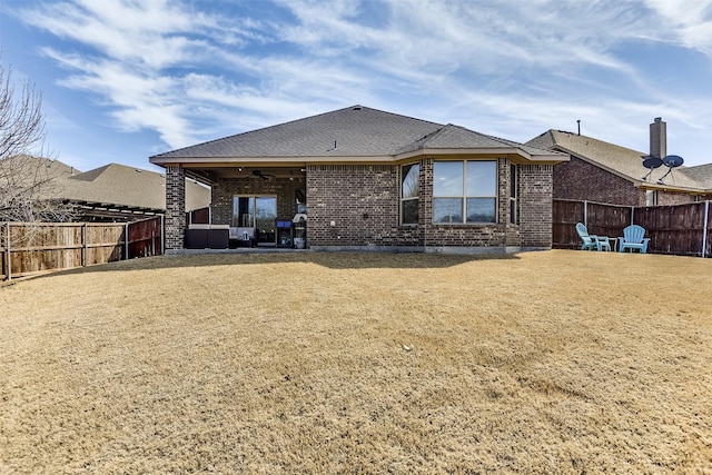 back of property featuring a patio area, a fenced backyard, ceiling fan, and brick siding