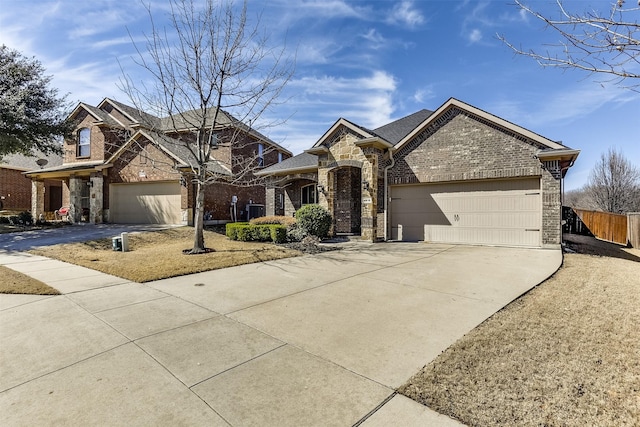 view of front of home featuring driveway, stone siding, central AC unit, and brick siding