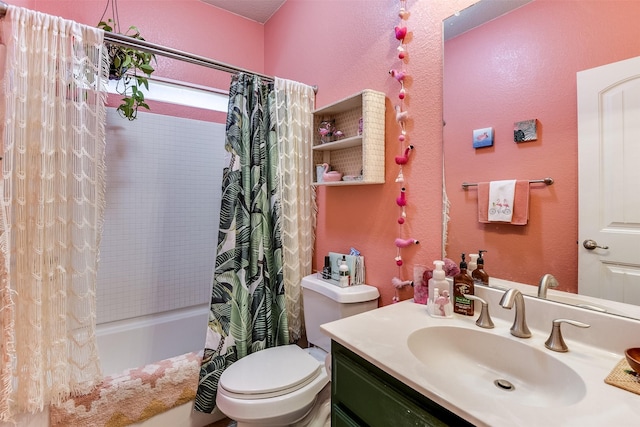 bathroom with a textured wall, shower / bath combo, vanity, and toilet