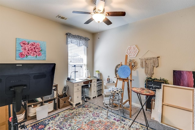 office space with baseboards, carpet flooring, visible vents, and a ceiling fan