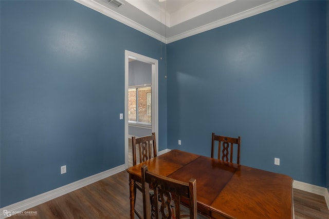 dining area featuring dark wood-style floors, ornamental molding, and baseboards