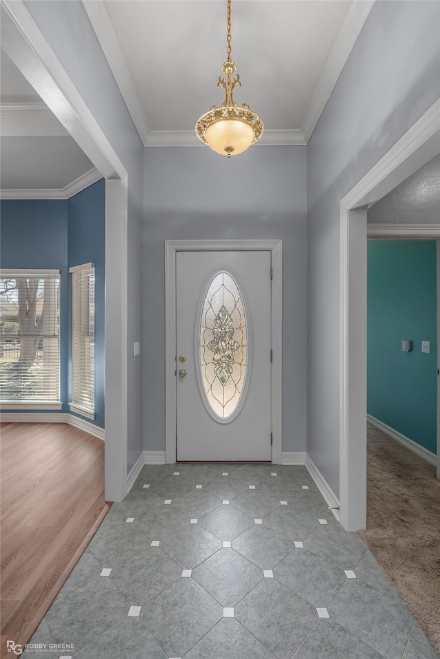 tiled foyer entrance featuring baseboards and ornamental molding