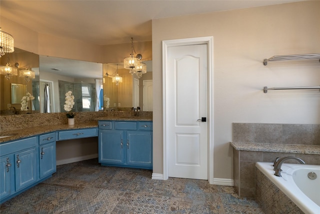 bathroom featuring vanity, a notable chandelier, a bath, and baseboards