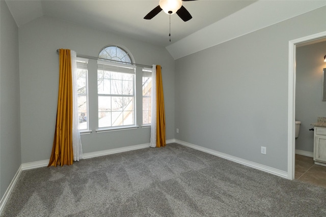 carpeted spare room with baseboards, lofted ceiling, and a ceiling fan