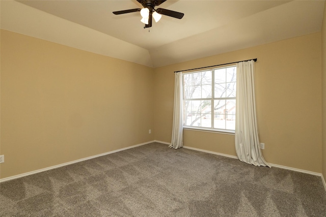 carpeted spare room featuring lofted ceiling, a ceiling fan, and baseboards