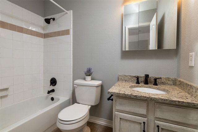 bathroom featuring bathing tub / shower combination, baseboards, toilet, and vanity