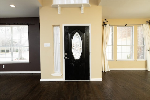 foyer with recessed lighting, wood finished floors, and baseboards