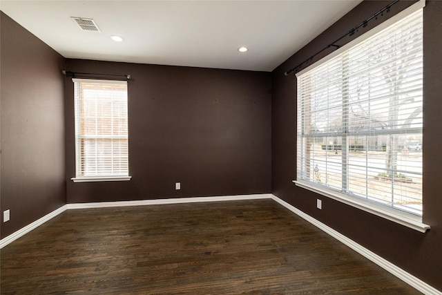 unfurnished room with visible vents, recessed lighting, baseboards, and wood finished floors