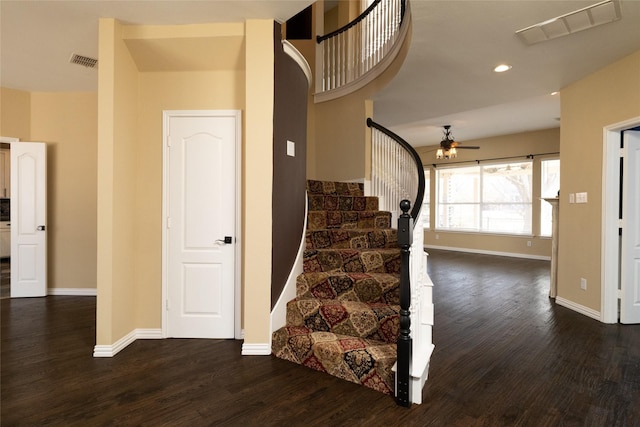 stairs featuring visible vents, baseboards, a ceiling fan, and wood finished floors