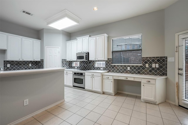 kitchen featuring appliances with stainless steel finishes, light tile patterned flooring, visible vents, and white cabinets