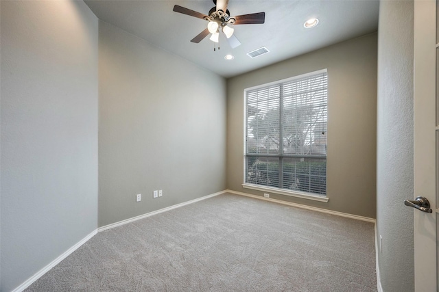 spare room with a ceiling fan, baseboards, visible vents, and carpet flooring