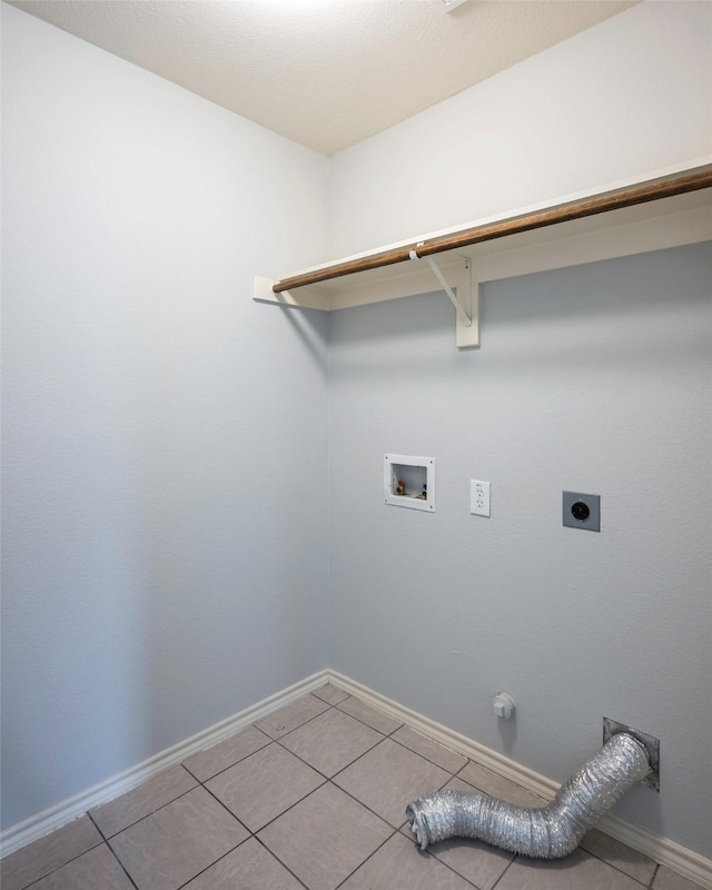 laundry area featuring laundry area, electric dryer hookup, baseboards, and light tile patterned floors