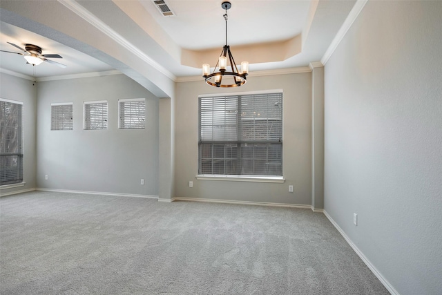 spare room featuring baseboards, visible vents, a raised ceiling, crown molding, and carpet floors