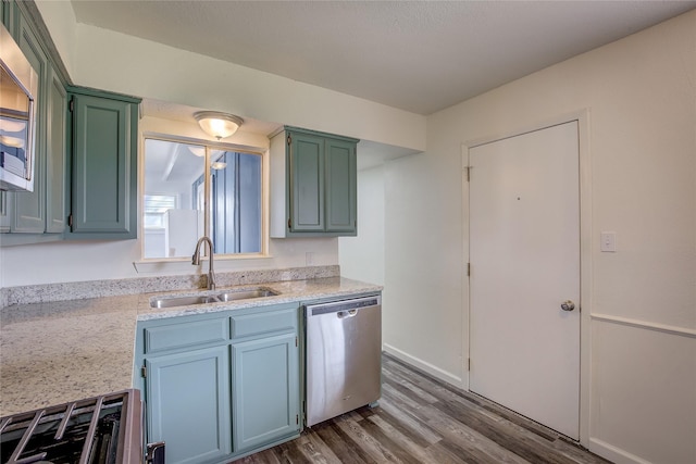 kitchen with green cabinets, stainless steel appliances, dark wood-type flooring, and a sink