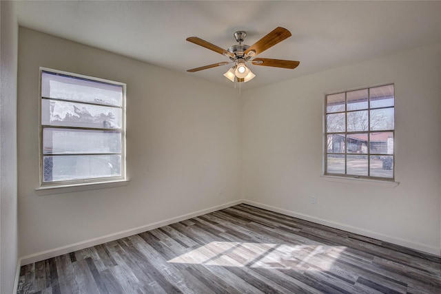 empty room with ceiling fan, baseboards, and wood finished floors