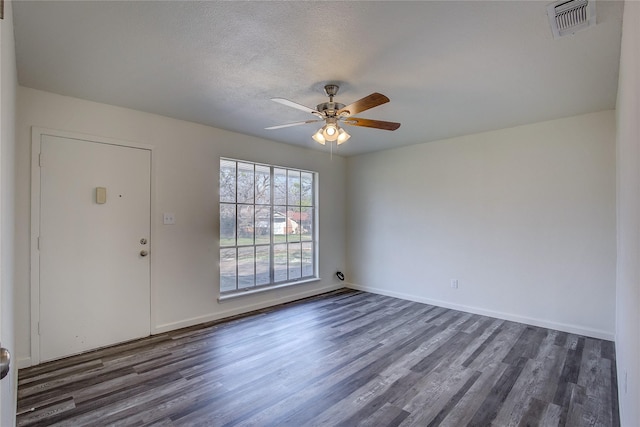 foyer entrance featuring ceiling fan, visible vents, dark wood finished floors, and baseboards