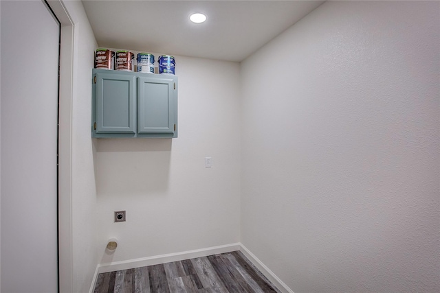 laundry room with cabinet space, baseboards, dark wood-style floors, and electric dryer hookup