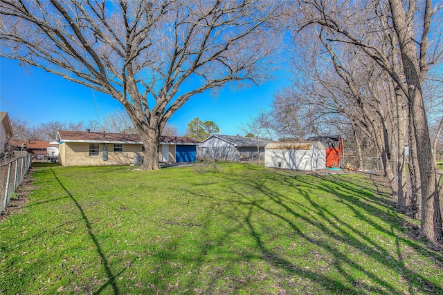 view of yard with a storage unit, an outdoor structure, and a fenced backyard