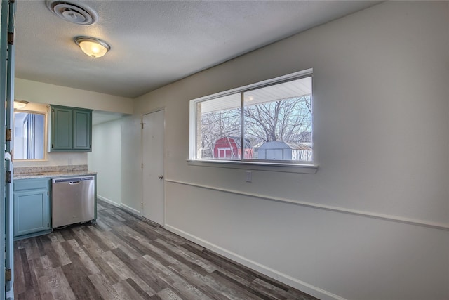 kitchen with visible vents, dark wood finished floors, dishwasher, light countertops, and a textured ceiling